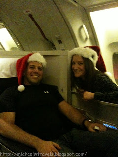 a man and woman wearing santa hats
