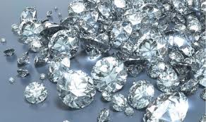 a pile of diamonds on a grey surface