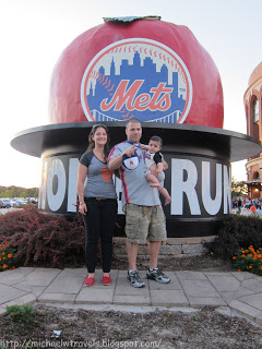 a man and woman standing in front of a large sign