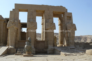 a stone structure with columns with Ramesseum in the background