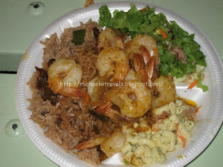 a plate of shrimp rice and salad
