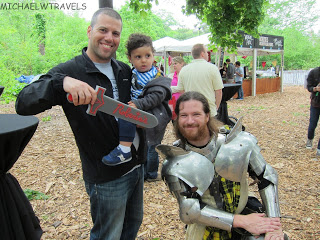 a man holding a sword and a child in armor