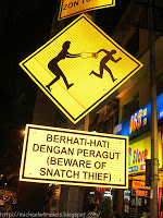 a yellow sign with a black and white sign