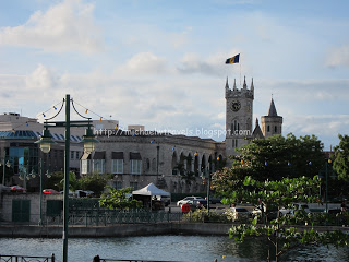 a building with a clock tower and a river