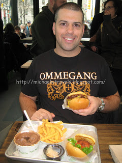 a man holding a burger and fries