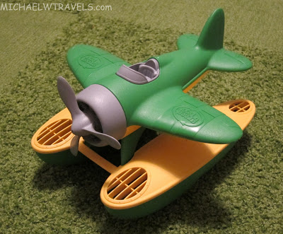 a green and yellow toy airplane