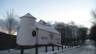 a white building with a flag on the side
