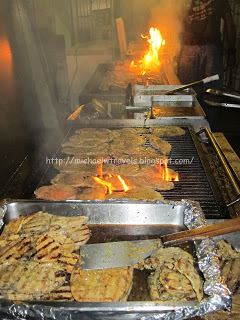 a large kitchen with food on a grill