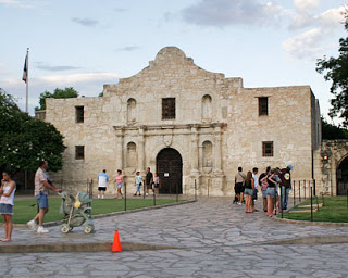 a group of people standing outside of Alamo Mission in San Antonio