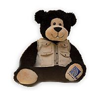 a stuffed bear wearing a vest