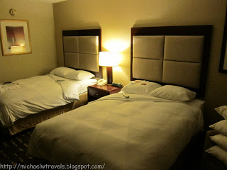 a hotel room with two beds