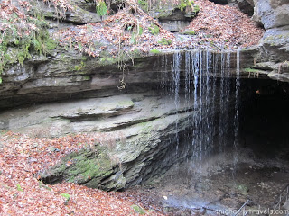 a waterfall coming out of a cave