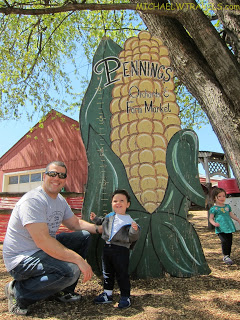 a man and a boy posing in front of a sign