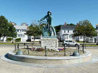 a statue of a man holding a wheel