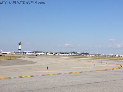 an airport runway with an airplane in the background
