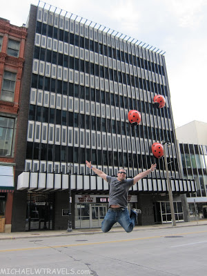 a man jumping in the air with red balls