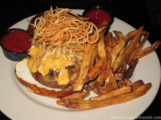 a plate of food with fries and cheese on it