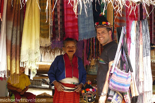 a man and woman standing in front of cloths