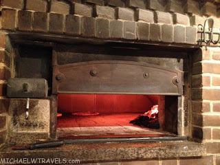 a brick oven with a fire inside
