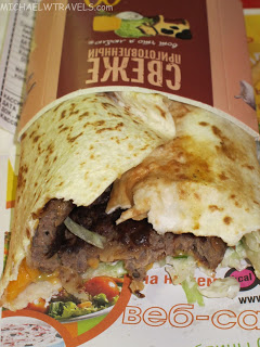 a burrito with meat and cheese