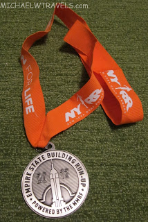a silver medal with a logo on it