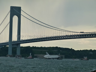a large bridge over water with Verrazano–Narrows Bridge in the background