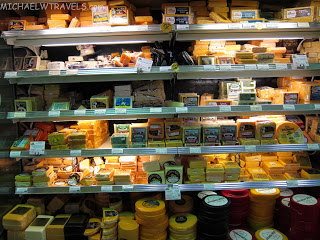 a shelf with different types of cheese