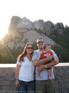 a family posing for a picture with a mountain in the background