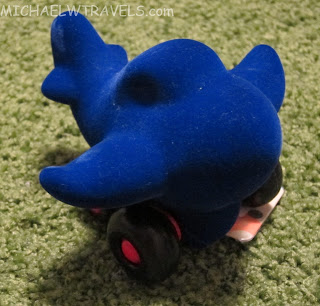a blue toy airplane on a skateboard