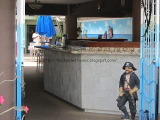 a statue of a pirate standing next to a bar