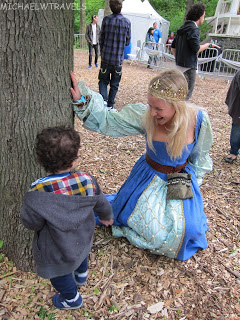 a woman in a blue dress and a child in a park