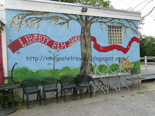 a wall painted with chairs and a tree