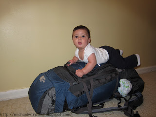 a baby lying on a backpack