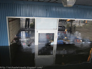 a flooded building with a glass door