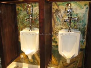a couple of urinals in a public bathroom